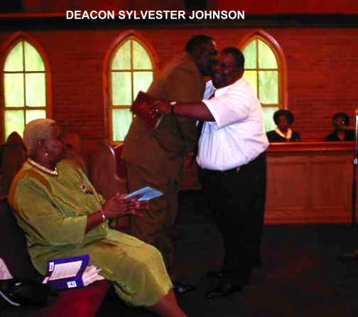  PHOTO TAKEN APRIL 28, 2002

DEACON CARLTON DAVIS PRESENTING THE BOOK OF SONGS
 .